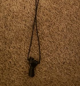 Black fist necklace